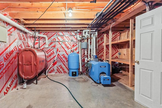 4 Acorn Ln, Lewiston, ME 04240 - unfinished basement featuring a water pressure tank, oil tank, and a heating unit