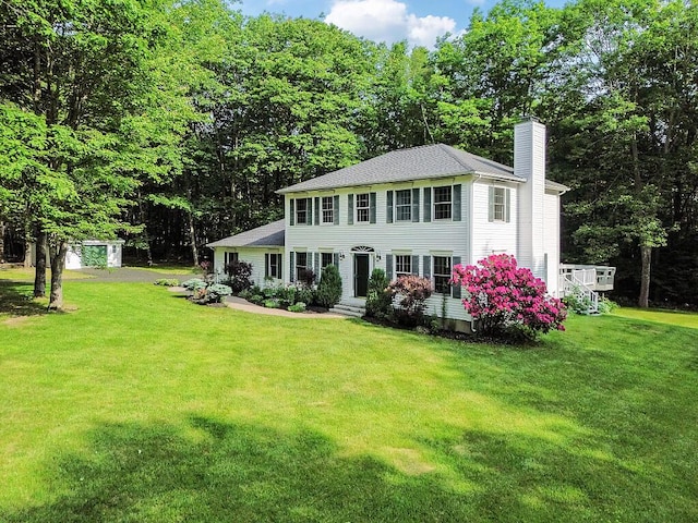 4 Acorn Ln, Lewiston, ME 04240 - colonial home featuring a chimney, a front lawn, and a shingled roof