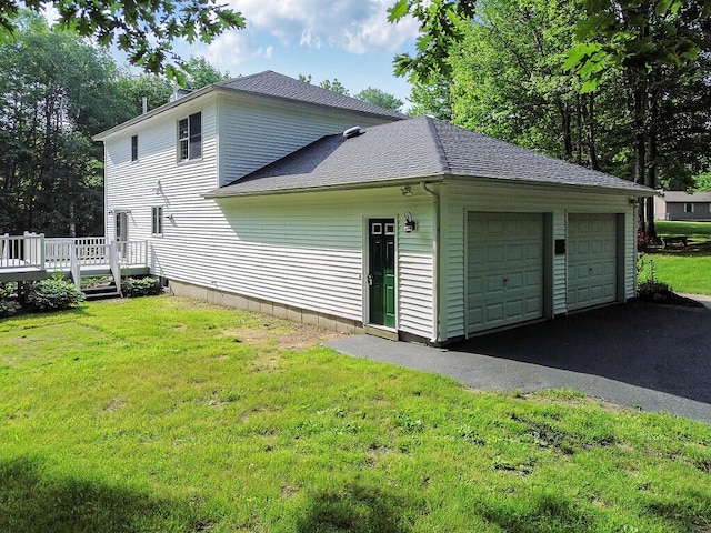 4 Acorn Ln, Lewiston, ME 04240 - view of side of home featuring a garage, a wooden deck, a shingled roof, and a lawn