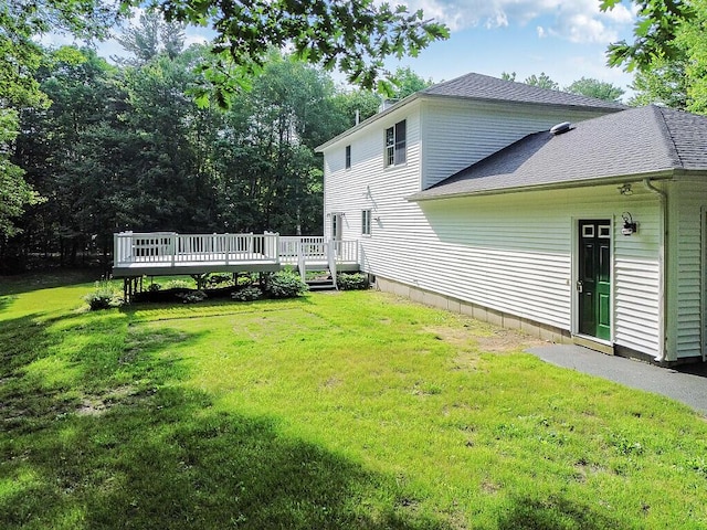 4 Acorn Ln, Lewiston, ME 04240 - back of house with a deck, a yard, and a shingled roof
