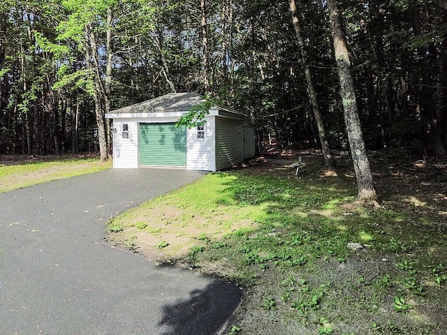 4 Acorn Ln, Lewiston, ME 04240 - garage featuring a view of trees