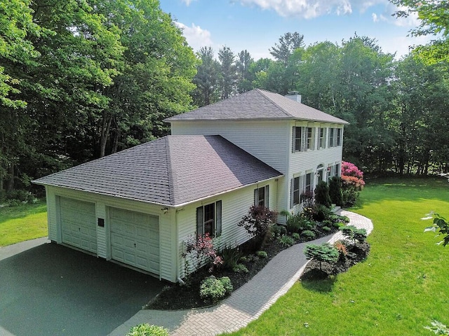 4 Acorn Ln, Lewiston, ME 04240 - view of side of home with a shingled roof, a lawn, and a chimney