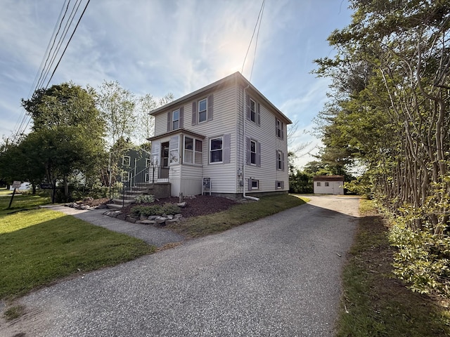 21 Peary Ter, South Portland, ME 04106 - view of front of house with a front lawn, an outdoor structure, and driveway