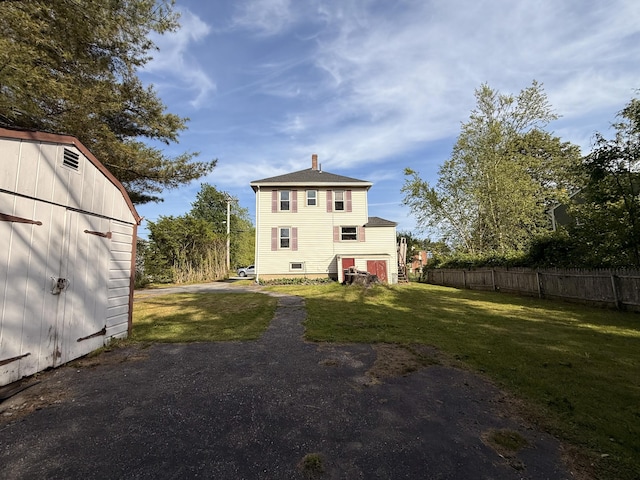 21 Peary Ter, South Portland, ME 04106 - back of house with a chimney, a shed, and a shingled roof