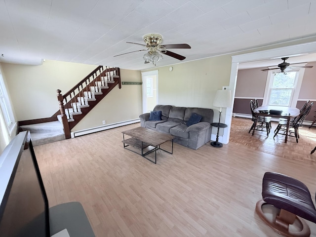 21 Peary Ter, South Portland, ME 04106 - living room with a baseboard radiator, a ceiling fan, stairs, wood finished floors, and a baseboard heating unit