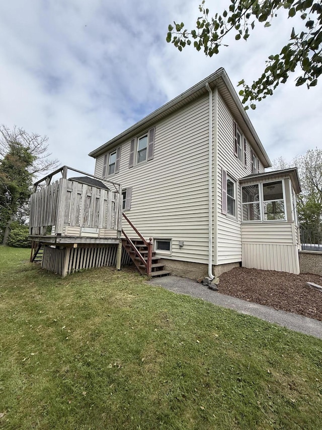 21 Peary Ter, South Portland, ME 04106 - back of house with a sunroom, a wooden deck, a lawn, and stairs