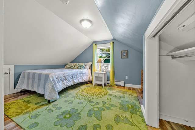 12 Fillmore Ave, South Portland, ME 04106 - bedroom with wood finished floors, a baseboard radiator, and lofted ceiling