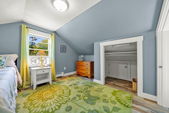 12 Fillmore Ave, South Portland, ME 04106 - bedroom with baseboard heating, light wood-style flooring, and vaulted ceiling