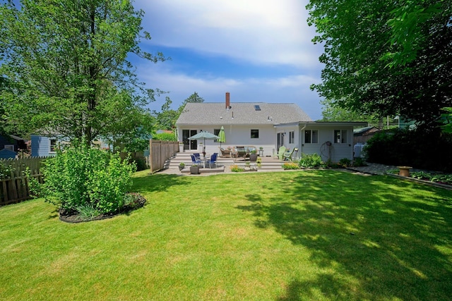 12 Fillmore Ave, South Portland, ME 04106 - rear view of property with a patio and a chimney