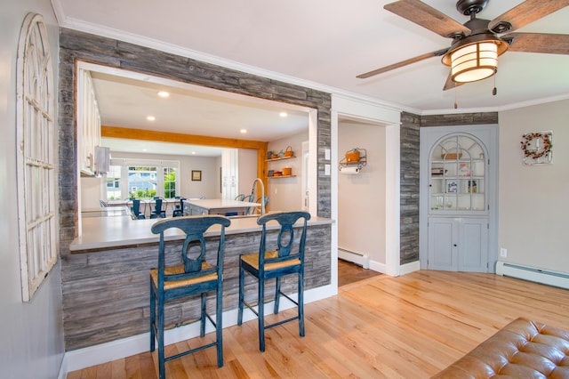 1 Madison St, Augusta, ME 04330 - kitchen featuring baseboard heating, light wood-type flooring, ornamental molding, white cabinets, and ceiling fan