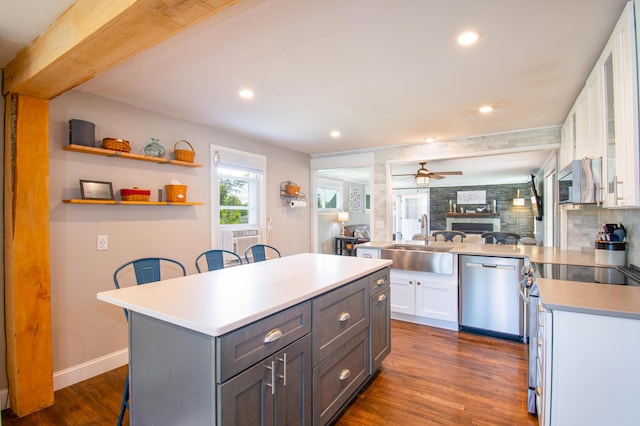 1 Madison St, Augusta, ME 04330 - kitchen featuring stainless steel appliances, a breakfast bar area, white cabinetry, dark wood-type flooring, and light countertops