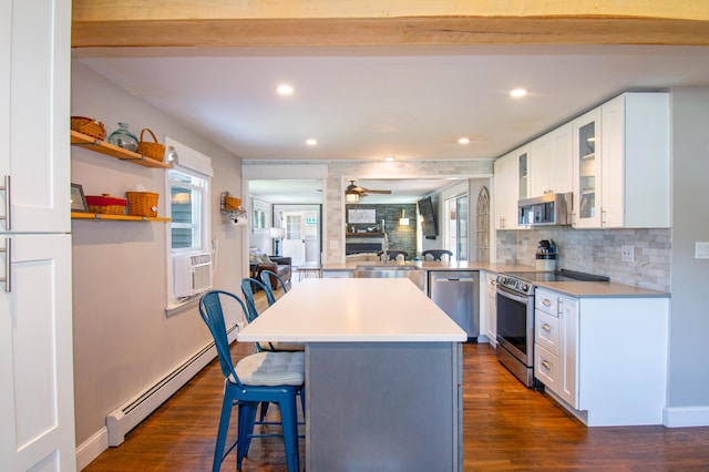 1 Madison St, Augusta, ME 04330 - kitchen with stainless steel appliances, a baseboard radiator, a kitchen breakfast bar, dark wood finished floors, and recessed lighting
