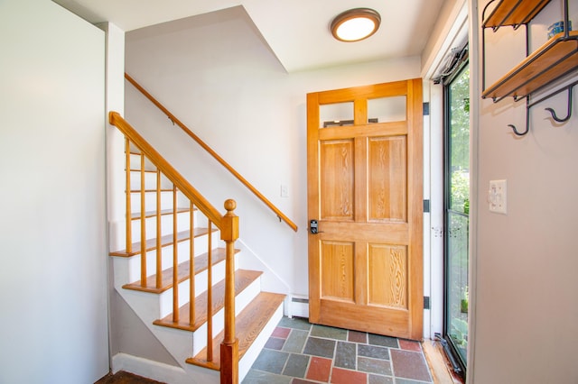 1 Madison St, Augusta, ME 04330 - entryway featuring a baseboard heating unit, dark stone finish floors, and stairs