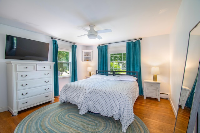 1 Madison St, Augusta, ME 04330 - bedroom featuring baseboard heating, multiple windows, wood finished floors, and a ceiling fan