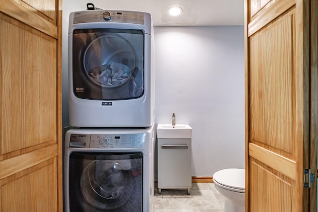 375 Gorham Rd, Scarborough, ME 04074 - laundry room featuring stacked washer / drying machine and baseboards