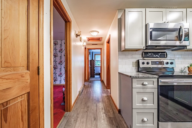 375 Gorham Rd, Scarborough, ME 04074 - kitchen featuring stainless steel appliances, wood finished floors, backsplash, and light stone countertops