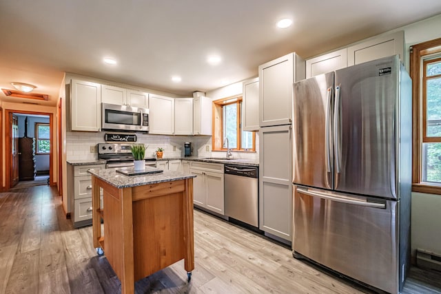 375 Gorham Rd, Scarborough, ME 04074 - kitchen featuring stainless steel appliances, stone countertops, a kitchen island, plenty of natural light, and recessed lighting