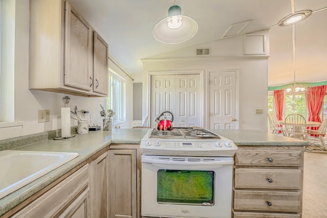 31 Herrick Rd, Belfast, ME 04915 - kitchen featuring white range with gas cooktop, a peninsula, light countertops, healthy amount of natural light, and vaulted ceiling