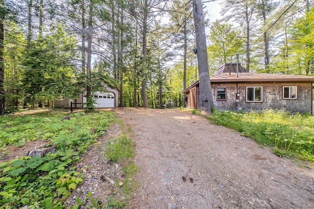 31 Herrick Rd, Belfast, ME 04915 - view of side of home featuring an outdoor structure, a garage, and asphalt driveway