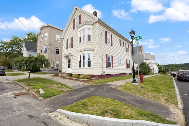 37 Cook St, Auburn, ME 04210 - view of home's exterior with a chimney and a lawn