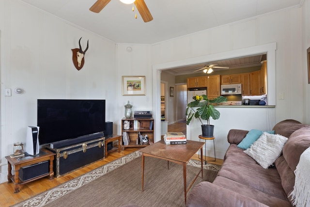 37 Cook St, Auburn, ME 04210 - living room with ceiling fan, light wood-style flooring, ornamental molding, and a decorative wall