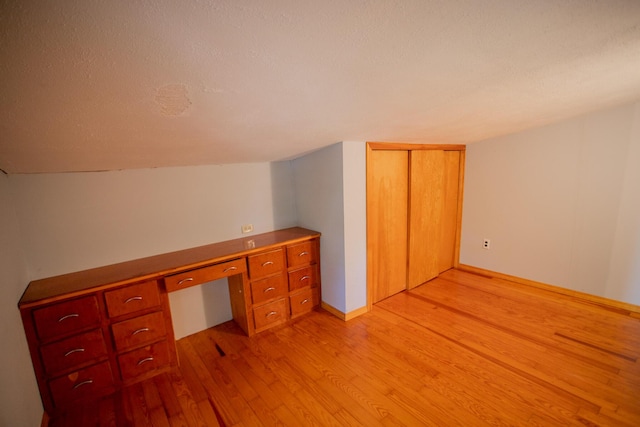 142 Military Rd, Greenbush, ME 04418 - unfurnished office with light wood-style flooring, built in study area, and a textured ceiling