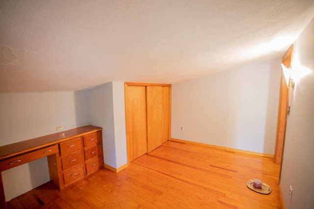 142 Military Rd, Greenbush, ME 04418 - unfurnished office with light wood-style floors, a textured ceiling, and built in desk