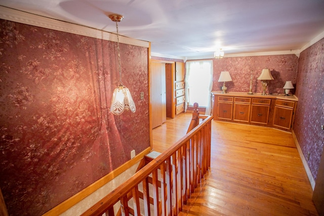 142 Military Rd, Greenbush, ME 04418 - hall featuring wallpapered walls, light wood-type flooring, and an upstairs landing