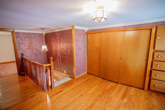 142 Military Rd, Greenbush, ME 04418 - unfurnished bedroom with wood finished floors, two closets, and crown molding