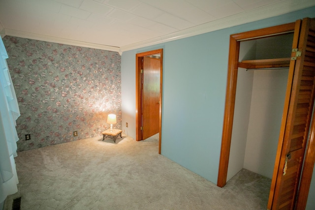 142 Military Rd, Greenbush, ME 04418 - unfurnished bedroom featuring carpet floors, wallpapered walls, a closet, and ornamental molding