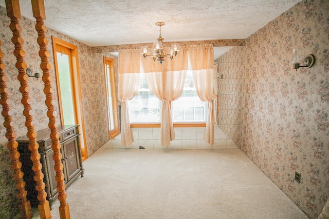 142 Military Rd, Greenbush, ME 04418 - unfurnished room featuring wallpapered walls, carpet flooring, a chandelier, healthy amount of natural light, and a textured ceiling
