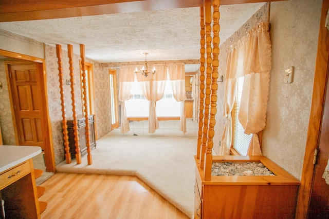142 Military Rd, Greenbush, ME 04418 - corridor featuring a chandelier, carpet, and wood finished floors