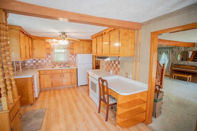 142 Military Rd, Greenbush, ME 04418 - kitchen with white appliances, ceiling fan, light countertops, exhaust hood, and light wood-style flooring