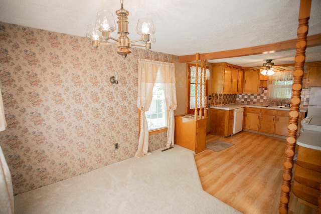 142 Military Rd, Greenbush, ME 04418 - kitchen featuring white dishwasher, light countertops, light wood-style floors, a chandelier, and ceiling fan