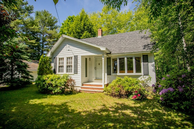 142 Military Rd, Greenbush, ME 04418 - bungalow-style home with a front yard, a chimney, and roof with shingles