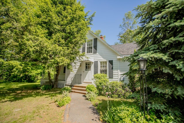 142 Military Rd, Greenbush, ME 04418 - obstructed view of property with a chimney, a shingled roof, and a front lawn