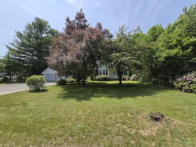 142 Military Rd, Greenbush, ME 04418 - view of green lawn featuring a garage and driveway