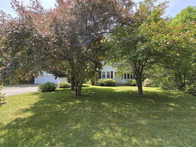 142 Military Rd, Greenbush, ME 04418 - view of front of home with concrete driveway and a front yard