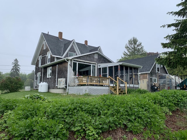 361 Water St, Addison, ME 04606 - rear view of house with a sunroom, a chimney, a shingled roof, an outdoor structure, and an exterior structure