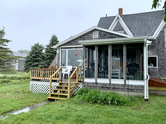361 Water St, Addison, ME 04606 - back of house featuring a sunroom, a chimney, a shingled roof, a deck, and a lawn