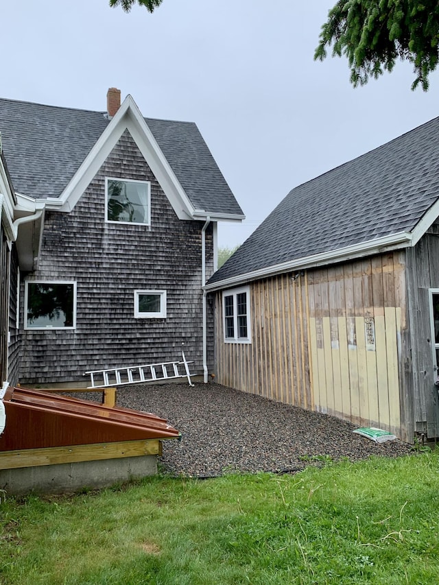361 Water St, Addison, ME 04606 - rear view of property featuring a chimney, roof with shingles, and a yard