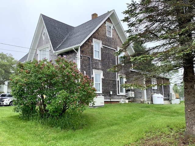361 Water St, Addison, ME 04606 - view of home's exterior featuring a shingled roof, a yard, and a chimney
