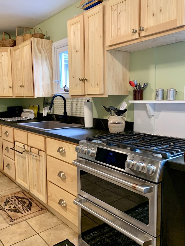 361 Water St, Addison, ME 04606 - kitchen with range with two ovens, light brown cabinets, dark countertops, and light tile patterned flooring