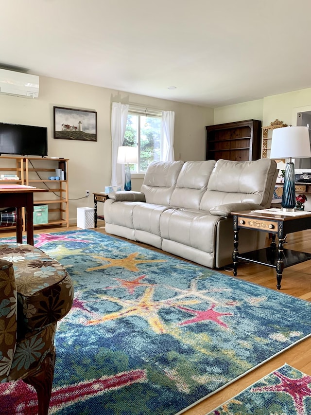 361 Water St, Addison, ME 04606 - living room with an AC wall unit and wood finished floors