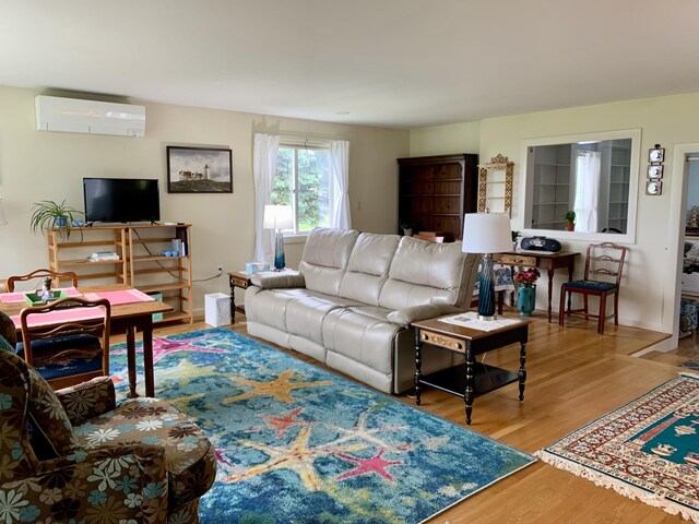 361 Water St, Addison, ME 04606 - living room featuring a wall unit AC and wood finished floors