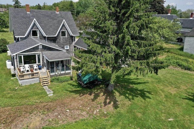 361 Water St, Addison, ME 04606 - rear view of property featuring a shingled roof, a chimney, a lawn, a deck, and a sunroom