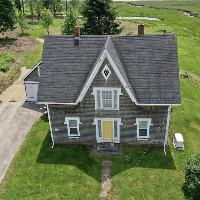 361 Water St, Addison, ME 04606 - view of front of home with a chimney, a front lawn, a shingled roof, and entry steps