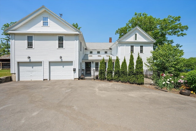 41 Main St, Old Town, ME 04468 - view of front of home with driveway, a garage, and a chimney