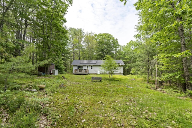 17 Eagle Ln, Damariscotta, ME 04543 - view of green lawn featuring a storage shed, a deck, and a forest view
