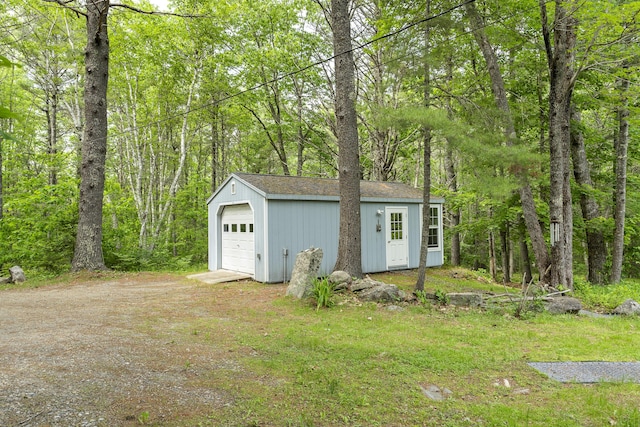 17 Eagle Ln, Damariscotta, ME 04543 - detached garage featuring dirt driveway and a view of trees